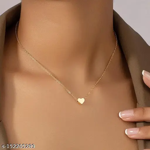 A woman models a gold heart pendant necklace, highlighting its beauty and suitability as a thoughtful gift.